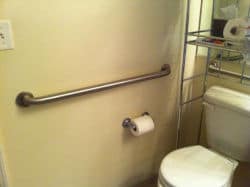 Wall-mounted grab bars provide secure support for added bathroom safety
